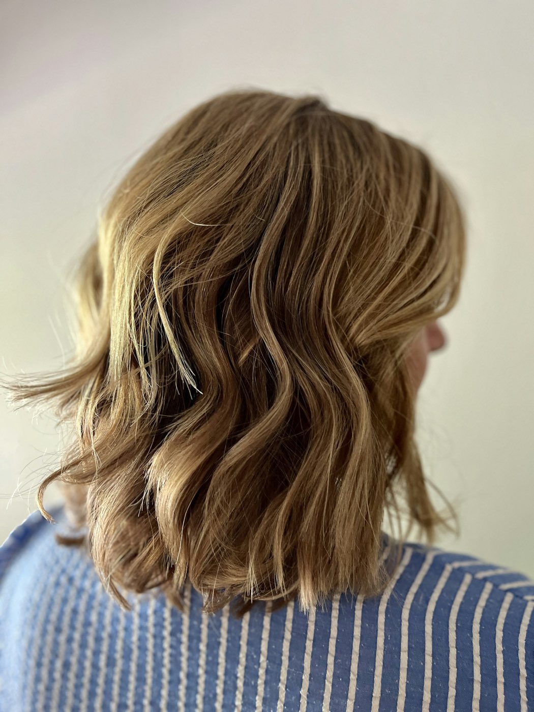 A wavy shoulder-length bob, seen from behind