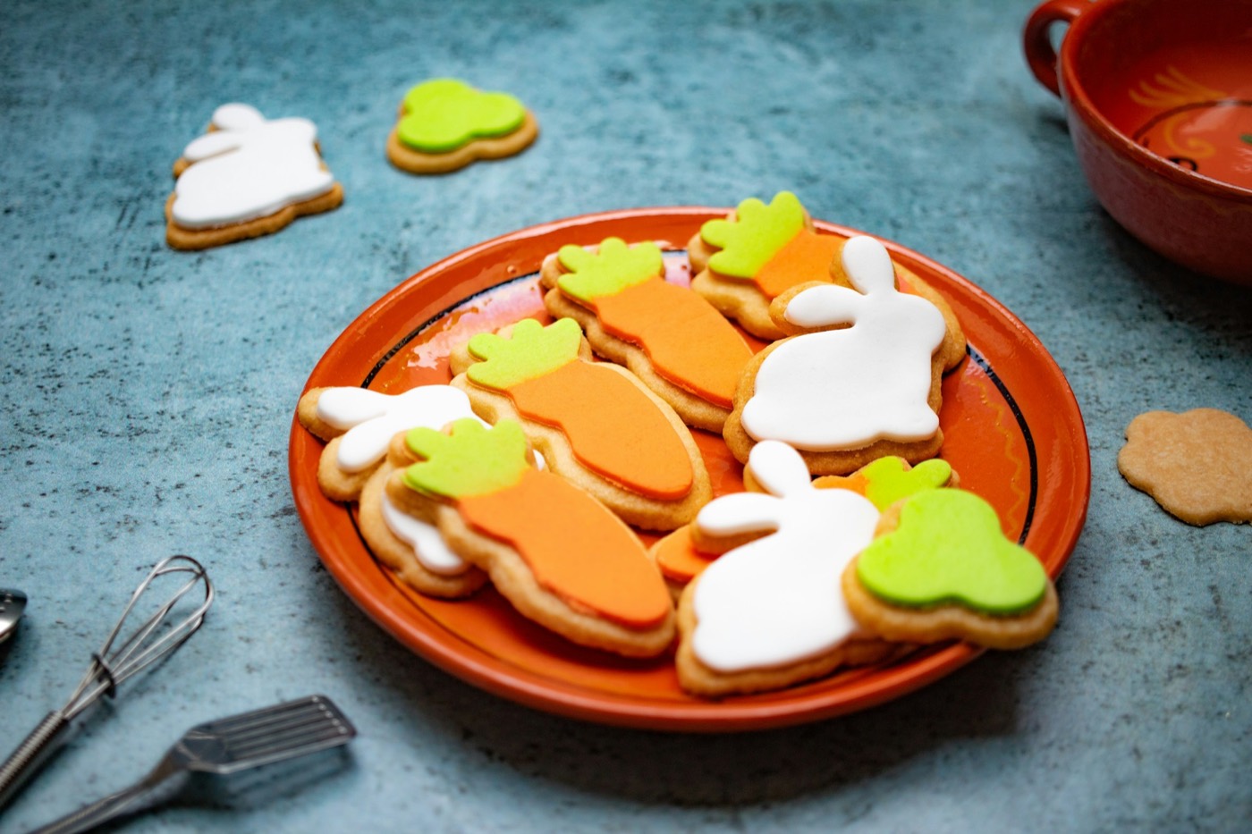 Plate of iced sugar cookies shaped like bunnies and carrots
