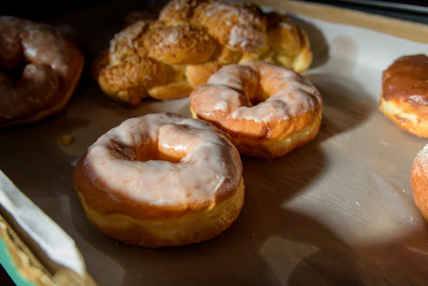 Glazed donuts and twisted pastries on a tray